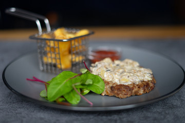 Steak with mushrooms on a gray background 