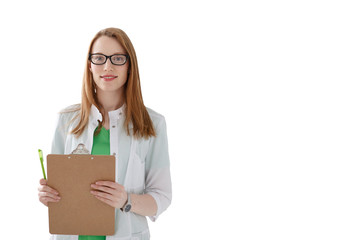 Portrait of friendly female doctor in medical gown with clipboard isolated on white background.