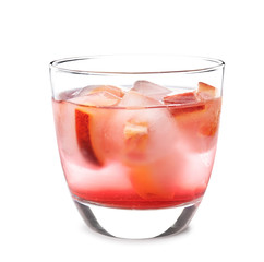 Glass of tropical cocktail with ice cubes on white background