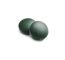 Spirulina tablets on white background. Healthy lifestyle