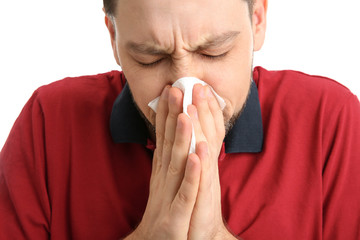 Man suffering from cold on white background, closeup