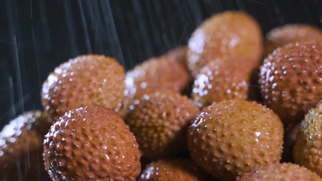 Splashes of water fall on lychee.