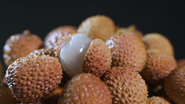 Fruits of thai frkuta litchi on a black background.