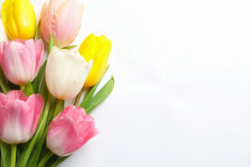 Obraz na płótnie Canvas Beautiful spring tulips on white background, top view. International Women's Day