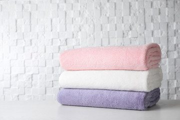 Fototapeta na wymiar Stack of soft bath towels on table