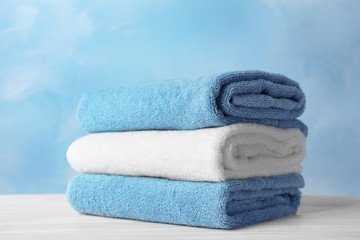 Fototapeta na wymiar Stack of soft bath towels on table
