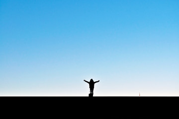 A lady raising her hands up