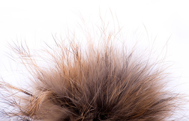 Fur pompom made of natural fur on a white isolated background
