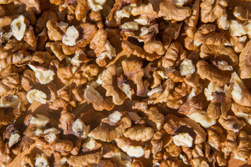 Closeup of Peeled Walnuts pile. Walnuts Background on wooden cutting board. Selective Focus, nuts with many different textures