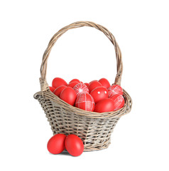 Fototapeta na wymiar Wicker basket with painted red Easter eggs on white background