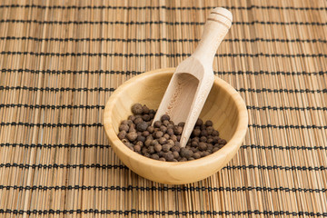 Pimentos on the wooden spoon isolated 