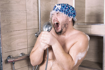 Funny fat man sings in the shower. 