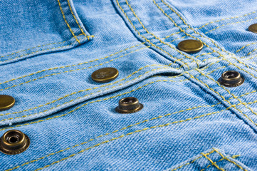 Blue washed faded jeans texture with seams, clasps, buttons and rivets