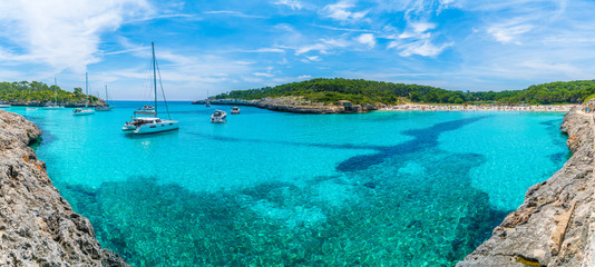 Naklejka na ściany i meble Landscape with boats and turquoise sea water on Cala Mondrago, Majorca island, Spain