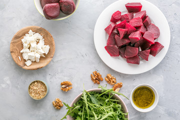 Ingredients ready for preparing beetroot salad with goat cheese and walnuts. flat lay