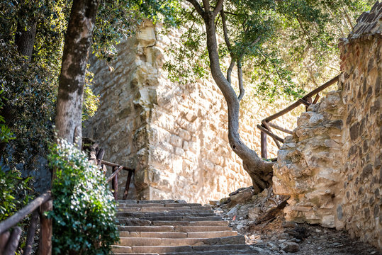 Castiglione del Lago, Italy Fortress stone steps stairs in Umbria Rocca with Medievale o Rocca del Leone and nobody low angle idyllic looking up by garden park