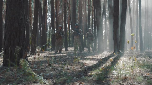 American soldiers patrol the perimeter in the forest