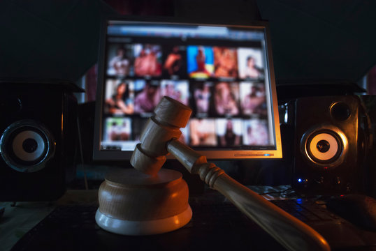Hammer on the background of the computer screen, illegal site with adult content,