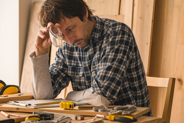 Carpenter planning DIY project in woodwork workshop