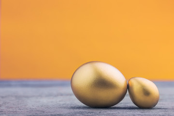 Background of Golden eggs on a wooden surface
