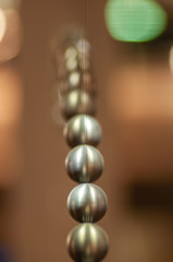 metal balls on string