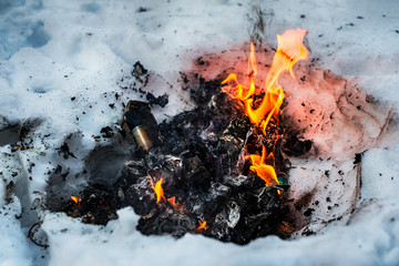Fire papers burning in snow