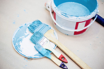 a bucket of paint and a paint tray and roller brush set