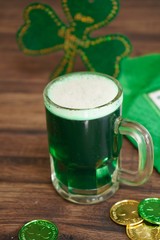 Green beer in a jar with lucky coins/ St Patrick's day