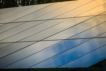 Fototapeta na wymiar Solar cells (photovoltaic panel) with the reflection of sunlight, blue sky and white clouds. Solar energy is radiant light and heat from the Sun such as solar heating and photovoltaics power plant.