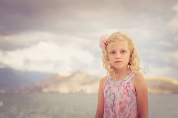 adorable little blond girl and the sea