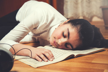 sleeping girl on music book