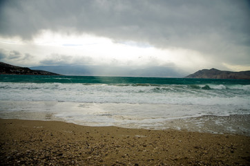stormy sea and pebble beach in dark atmosphere