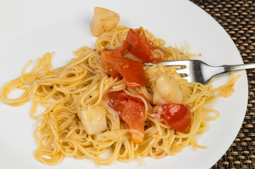 Bits of Scallop on Pasta with Onion and Tomatoes sprinkled with Parmesan Cheese