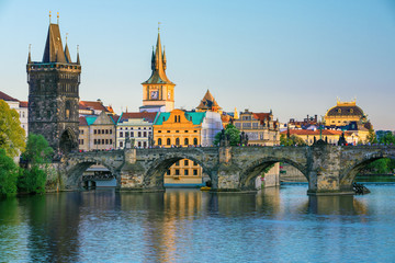 Fototapeta na wymiar Scenic view on Vltava rive, Charles bridge and historical center of Prague, buildings and landmarks of old town at sunset, Prague, Czech Republic