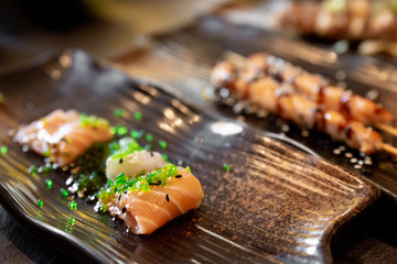 Salmon and sea bream sushi and tuna skewers of typical Japanese cuisine