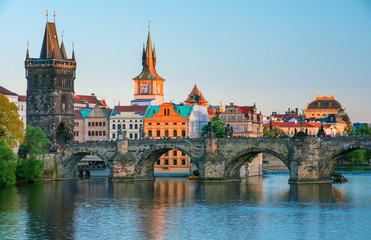 Scenic view on Vltava rive, Charles bridge and historical center of Prague, buildings and landmarks of old town at sunset, Prague, Czech Republic