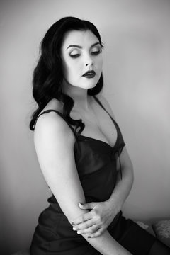 Black and white portrait of beautiful model girl with pinup style make up
