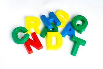 Many multicolored children's letters on a white background. Learning, manipulation