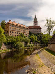 Fototapeta na wymiar View of the Unesco World Heritage City Cesky Krumlov in the Czech Republic with historic buildings, churches and narrow streets in front of blue sky