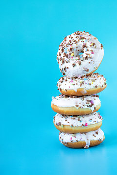 Donuts on a blue background. Sweets, pastries.	