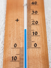 wooden thermometer showing 15 degrees with blue line