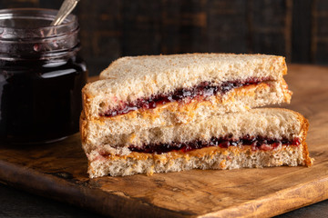 Peanut Butter and Grape Jelly Sandwich on a Wooden Cutting Board