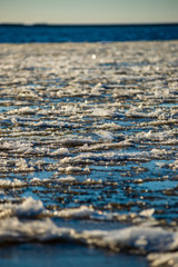 frozen ice blocks on sea beach in winter