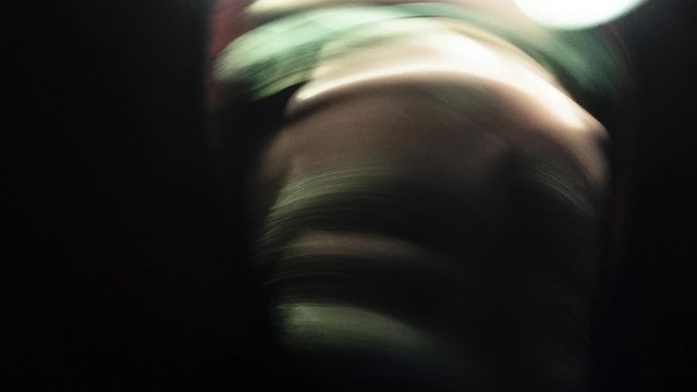 Weird man in the dark. Stop Motion Hallucination. A man with glasses and a flashlight on his forehead. Time Lapse