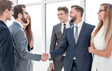 employees greet each other with a handshake