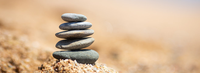 Balance of stones on the beach, sunny day