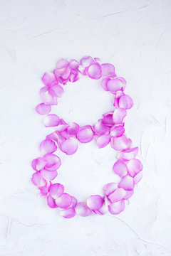 The figure 8 of rose petals on a white background. Pink roses for women's holiday. Photo or postcard in the concept of a romantic gift. Free place for text. Isolated image.