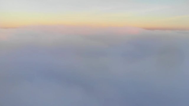 aerial shot above thick clouds upper surface against horizon