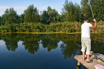 Sport fisherman on the platform