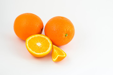 Oranges on a white background, juicy orange fruits. Useful tropical citrus fruits for a healthy diet.